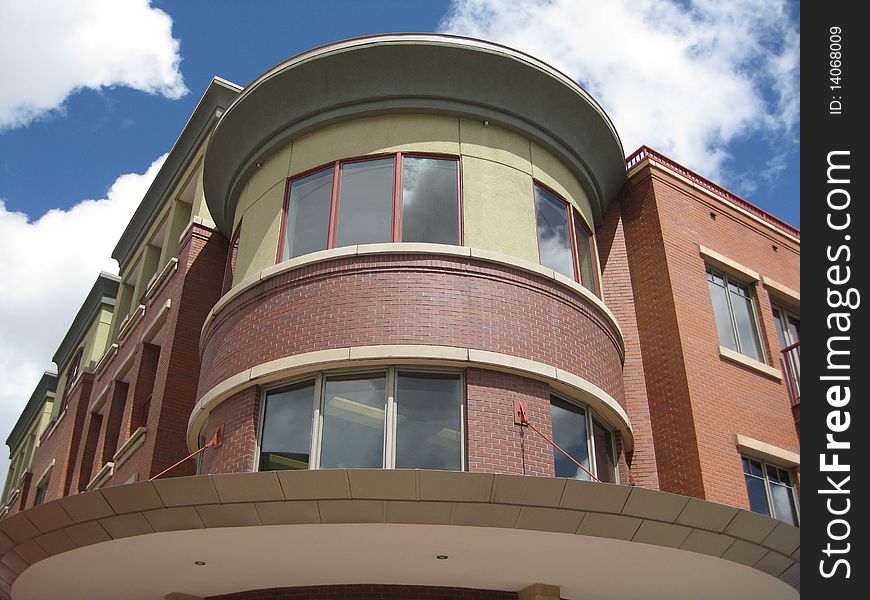 A very unique and asymmetrical design are shown off against the bright blue and white puffy clouds of the sky in Boulder Col. A very unique and asymmetrical design are shown off against the bright blue and white puffy clouds of the sky in Boulder Col