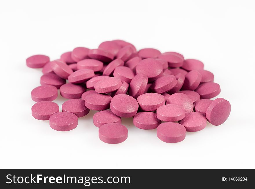 Magenta pills on a white background