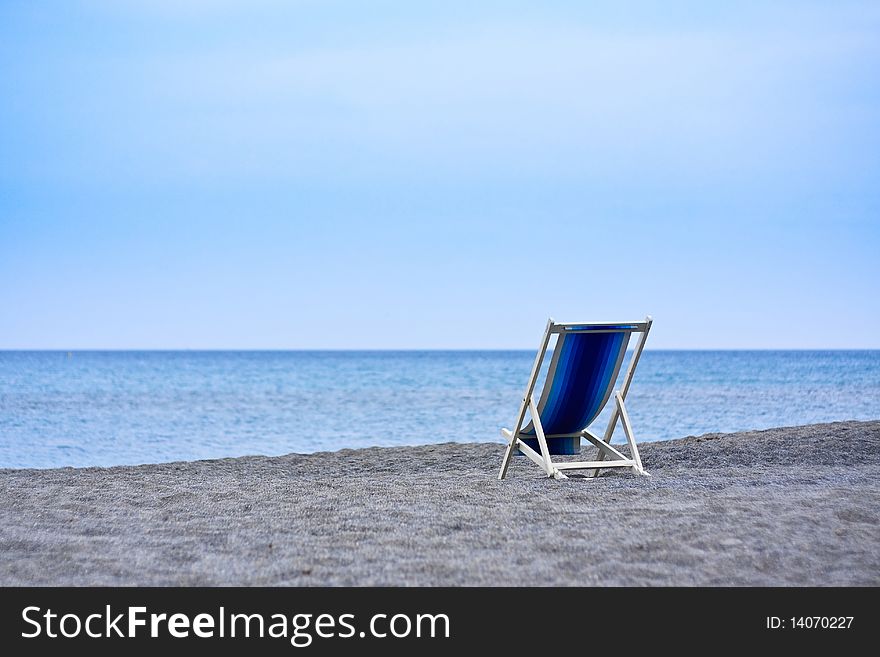 Empty Deck Chairs Facing The Sea