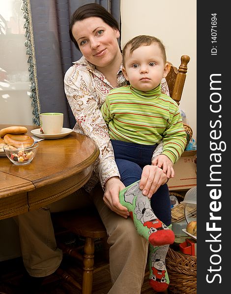 Young woman with little son in the living room