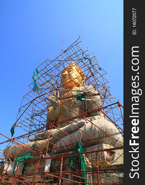 Gold Buddha under construction at top of the mountain, Phetchaburi Thailand