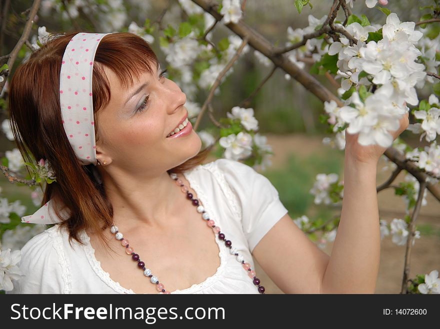 Beautiful young girl is happy flowering apple tree. Beautiful young girl is happy flowering apple tree