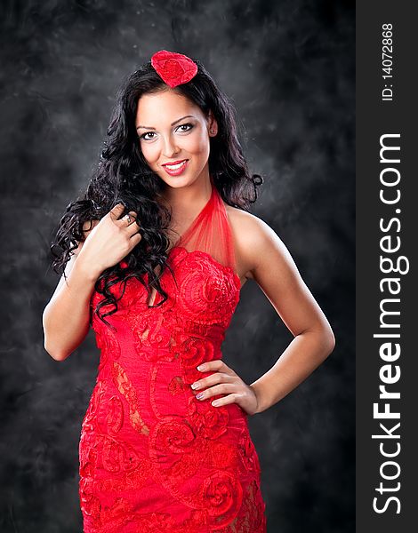 Glamorous woman with black dress and beautiful hair, studio shot