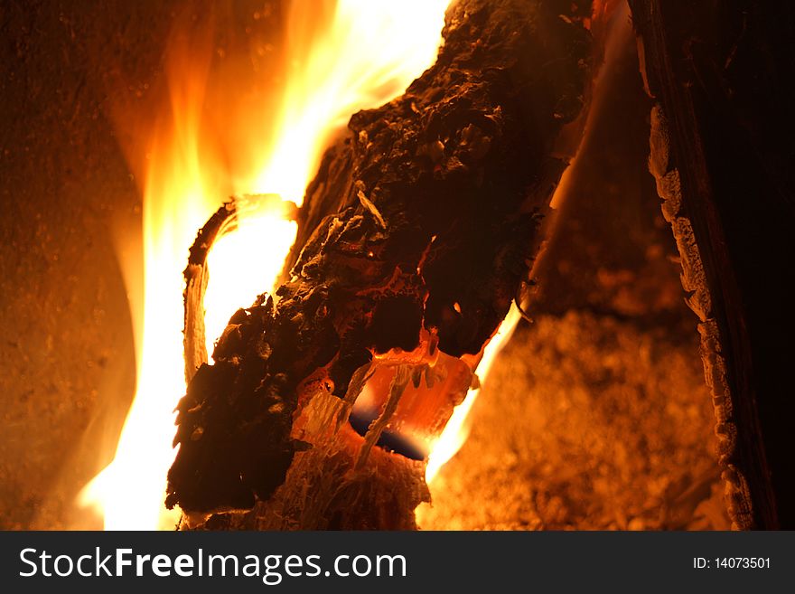 Fire in the log with red and yellow flames. Fire in the log with red and yellow flames