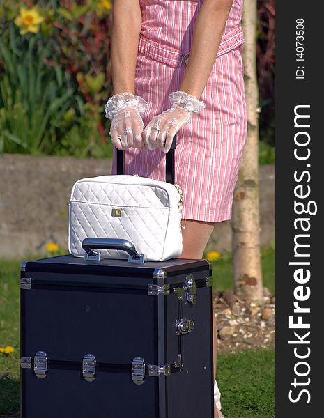 Elegant woman holding on to her luggage. Elegant woman holding on to her luggage