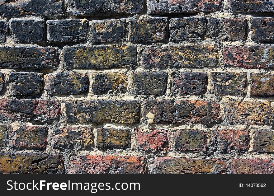 Red and black painted thick brick wall