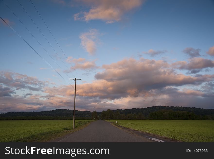 Rural Highway Under Sunset Clouds