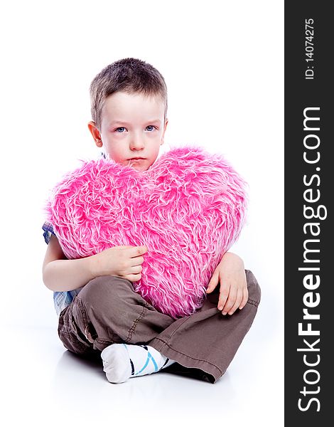 Cute baby boy holding a heart-fur and pink