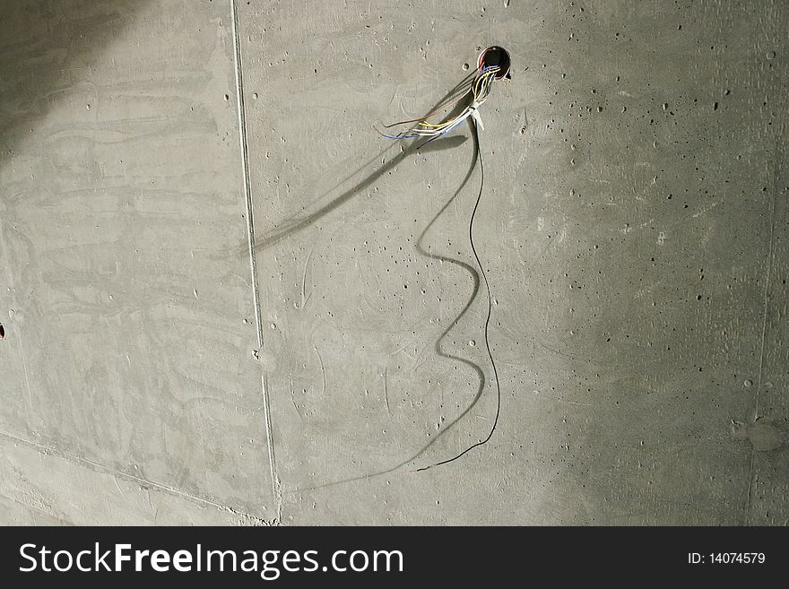 A brand new building under construction with electrical cords on a wall. A brand new building under construction with electrical cords on a wall