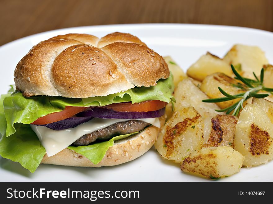 Hamburger, tasty burger with roasted potatoes. Hamburger, tasty burger with roasted potatoes