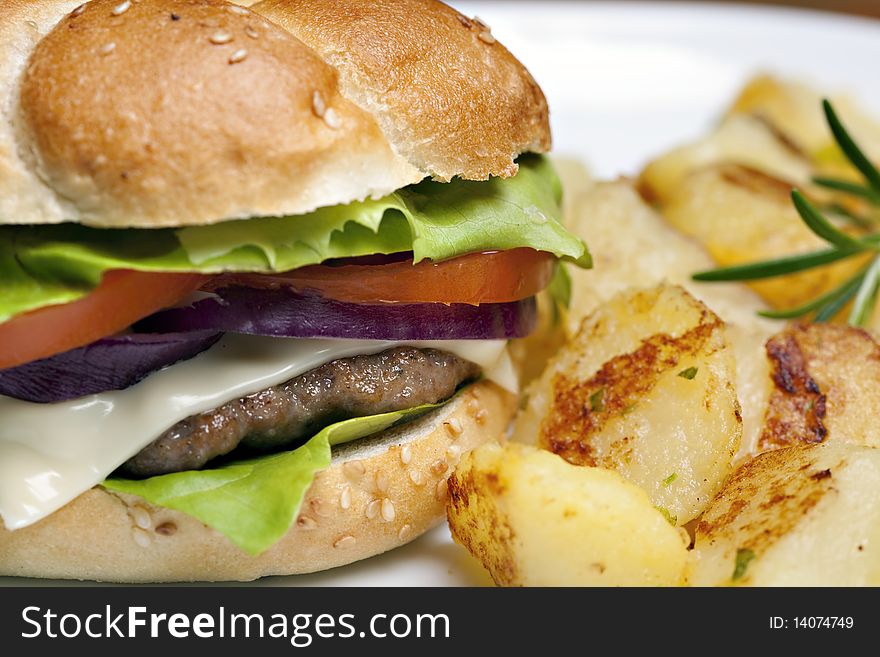 Hamburger, tasty burger with roasted potatoes. Hamburger, tasty burger with roasted potatoes