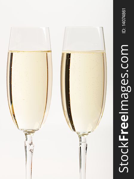 Two flutes with champagne isolated on white background. Two flutes with champagne isolated on white background