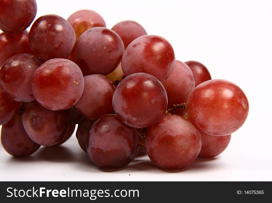 Red grapes in close up on white background