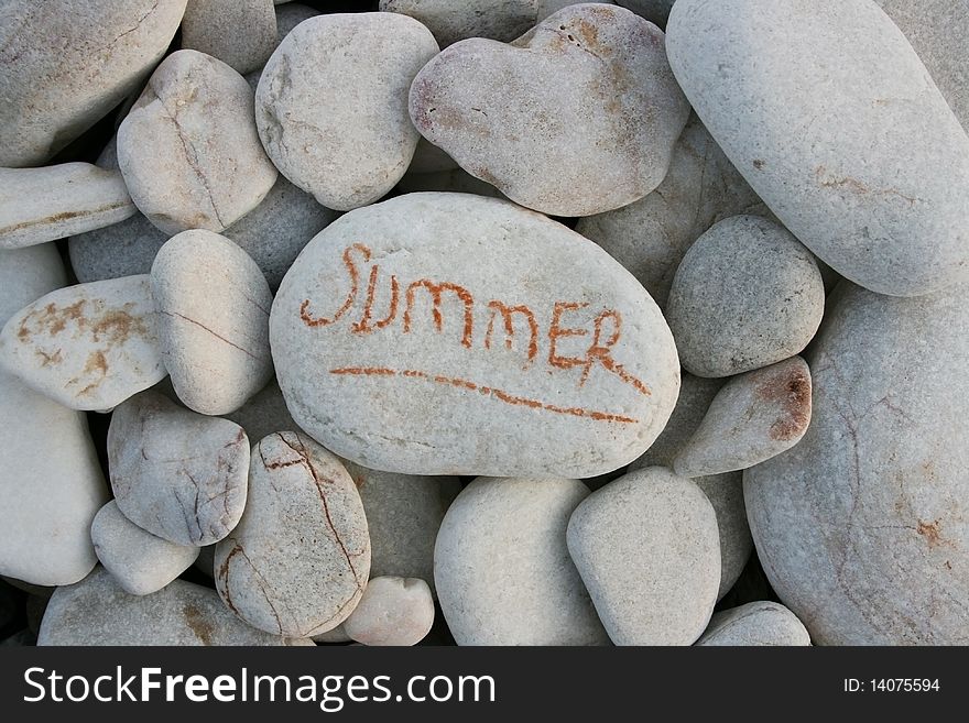 A  white stone which written 'summer' in lots of stones. A  white stone which written 'summer' in lots of stones.