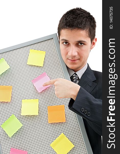 A businessman holding a reminder board with plenty of colorful post-it on it. A businessman holding a reminder board with plenty of colorful post-it on it