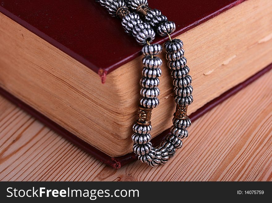 Ancient chain on the thick old book, a religion theme.