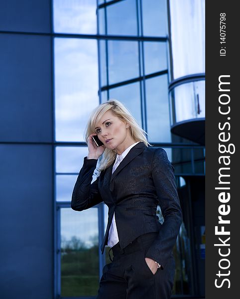 Beautiful business woman on the phone at modern building