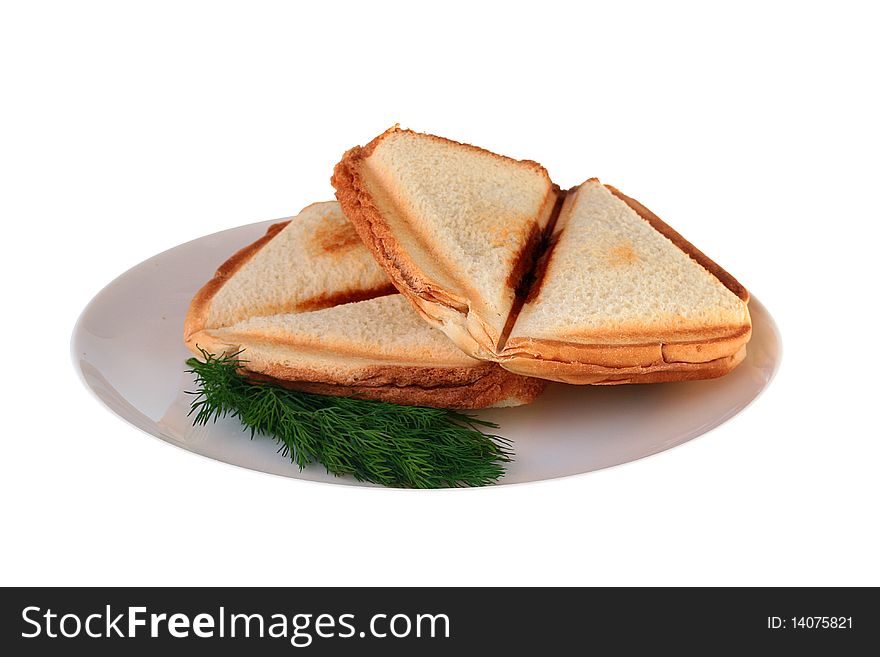 The hot sandwich is prepared in a roaster on a plate together with a fennel branch.