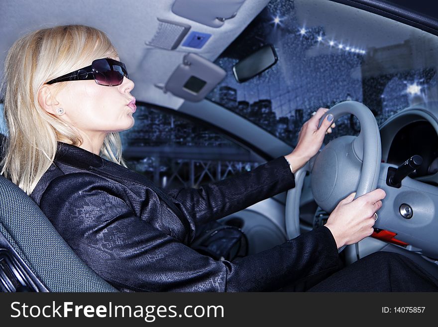 Blonde Young woman driving car -side view on person