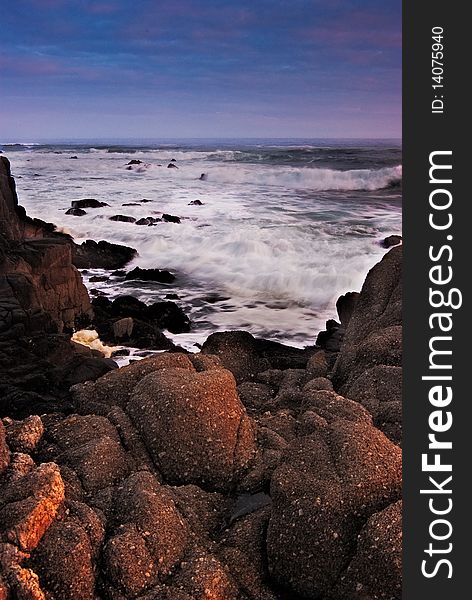 Details of the waves crashing on the beach with details of the rocks and sky. Details of the waves crashing on the beach with details of the rocks and sky