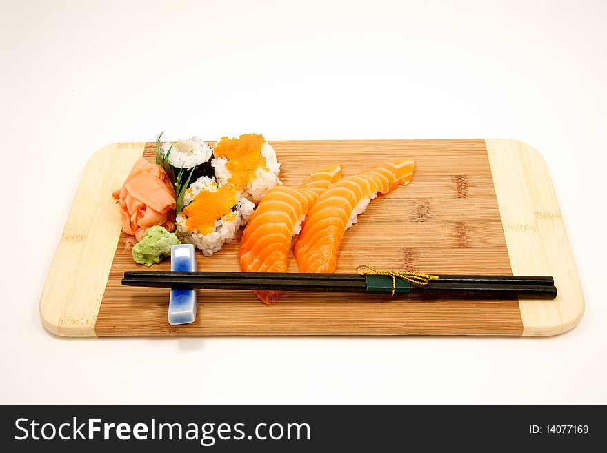 Fresh sushi on cutting board with chop sticks. Fresh sushi on cutting board with chop sticks