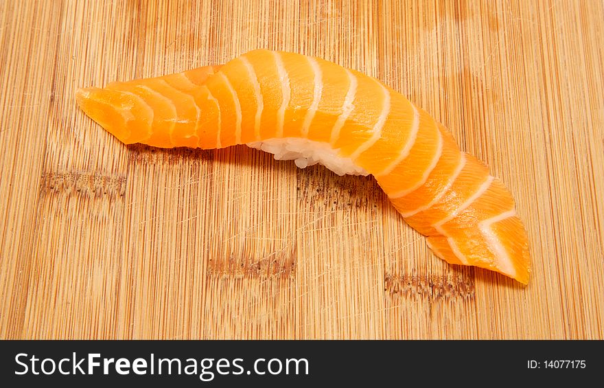 Fresh salmon nigiri on bamboo board