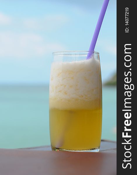 A glass of papaya juice inside the beach. A glass of papaya juice inside the beach