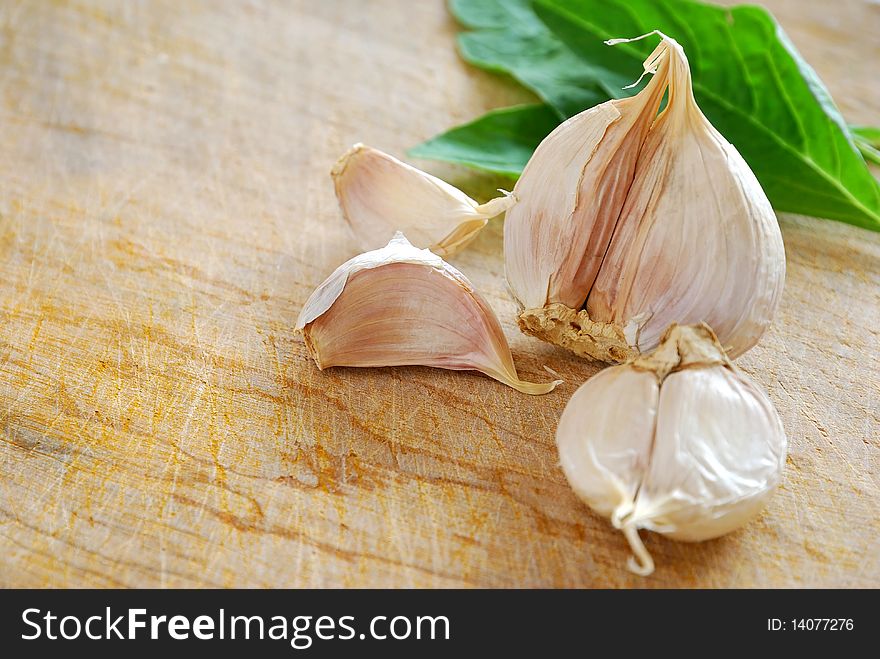 Isolated fresh white garlic on cutting board. Commonly used as seasoning and food ingredient in many Chinese cuisine. For food and beverage concepts.