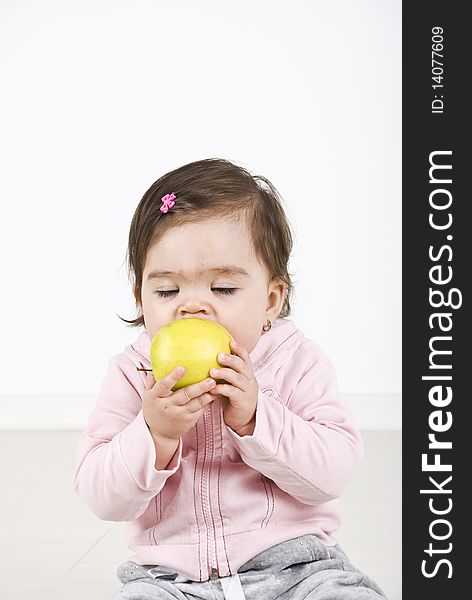 Baby girl bite an apple and enjoying with eyes closed ,copy space for text message.Check also Children. Baby girl bite an apple and enjoying with eyes closed ,copy space for text message.Check also Children