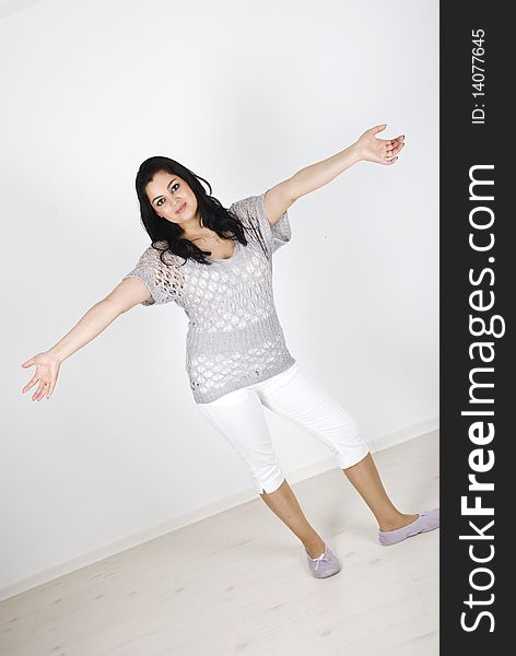 Beautiful woman full length standing with open arms in welcoming gesture.Check also Facial expressions and gesture. Beautiful woman full length standing with open arms in welcoming gesture.Check also Facial expressions and gesture