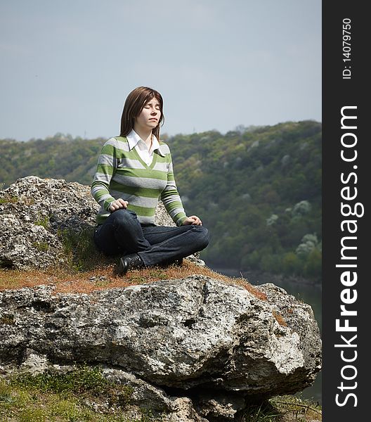 Outdoor shot. relax girl on stone