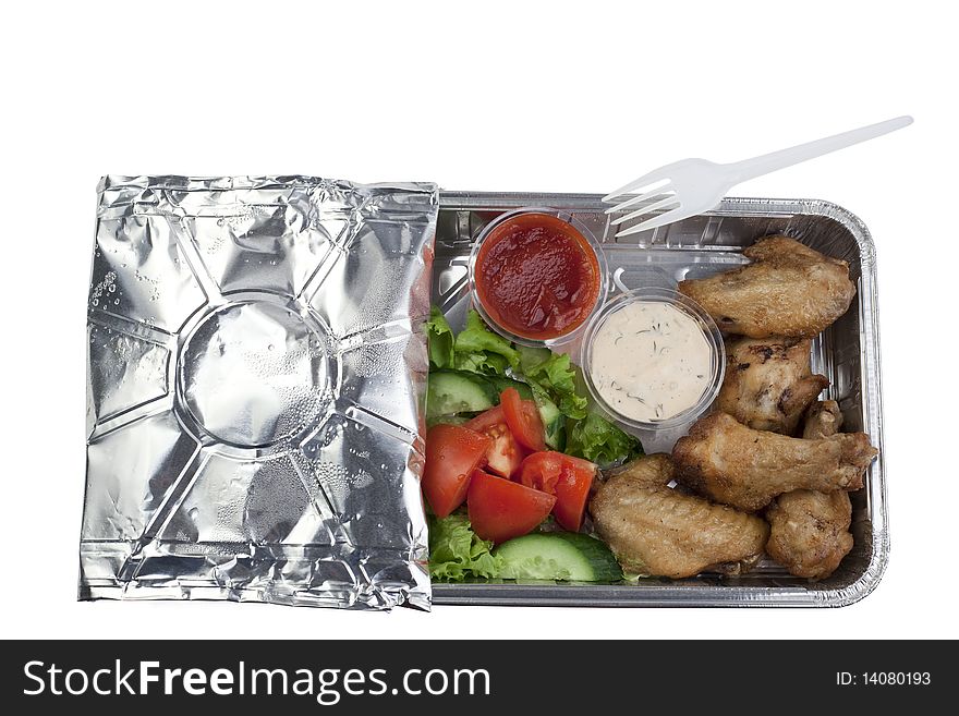 Vegetables,chicken wings, sauces in a package. Vegetables,chicken wings, sauces in a package