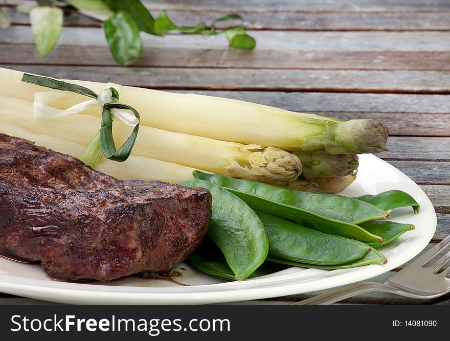 Nice juicy flame grilled Filet Mignon with Asparagus and Snow pea. Nice juicy flame grilled Filet Mignon with Asparagus and Snow pea