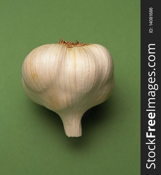 Head of garlic on green