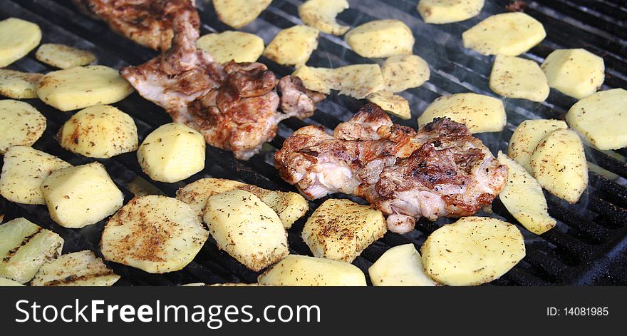 Chicken and potatoes on grill. Chicken and potatoes on grill