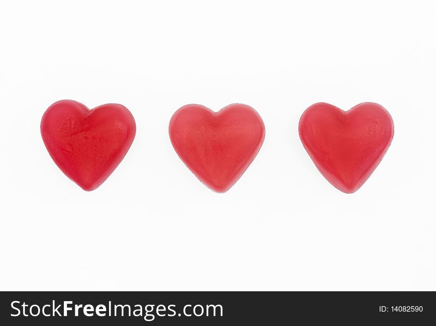 Red and white love heart sweets on a white background