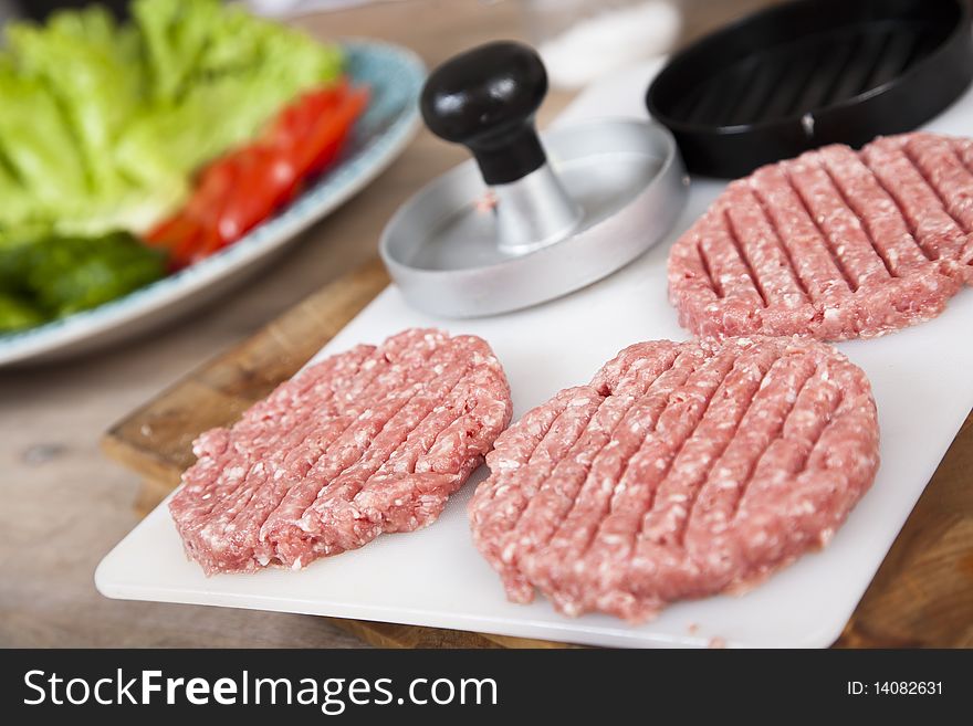 Fresh, homemade hamburgers waiting to be cooked. Shallow d o f. Fresh, homemade hamburgers waiting to be cooked. Shallow d o f