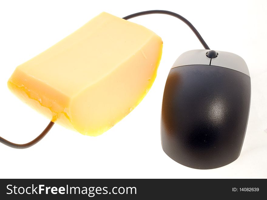 Black, wired computer mouse next to a chunk of yellow cheese