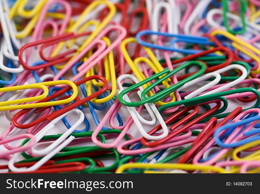 Multicolored paperclips on a white background