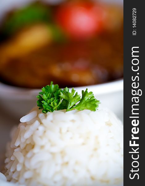 Closeup shot of a saucy lamb tjop dish with the rice in focus. Closeup shot of a saucy lamb tjop dish with the rice in focus.