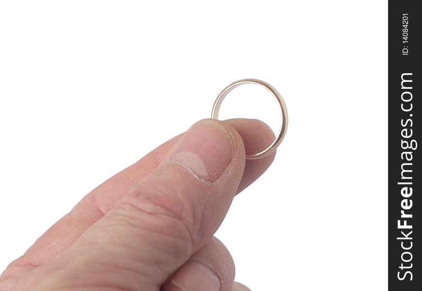 Wedding ring in hand fingers on a white background close up it is isolated. Wedding ring in hand fingers on a white background close up it is isolated