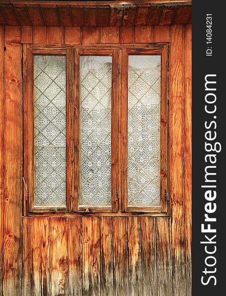 Old romanian wooden window with wall texture. vertical view. Old romanian wooden window with wall texture. vertical view