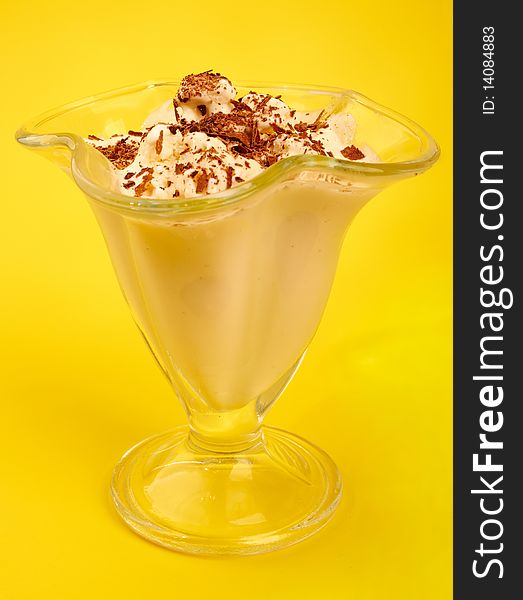 Ice-cream with chocolate on yellow background