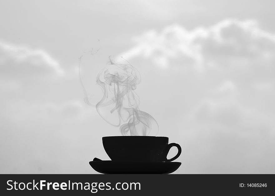 Black and white shot, big contrast, coffee cup on clouds background. Black and white shot, big contrast, coffee cup on clouds background