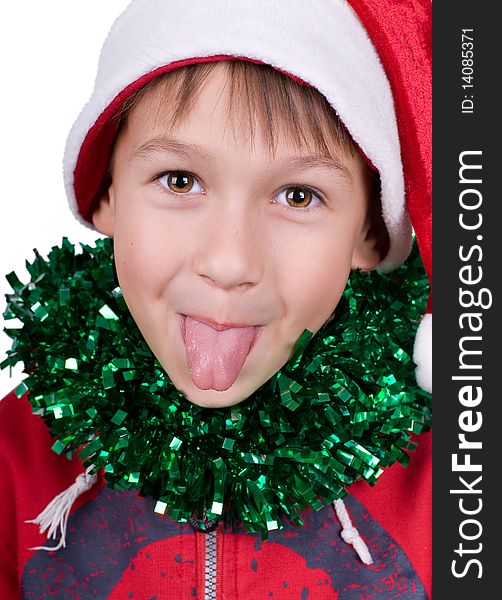 Cute small boy with santa's hat puts out the tongue isolated