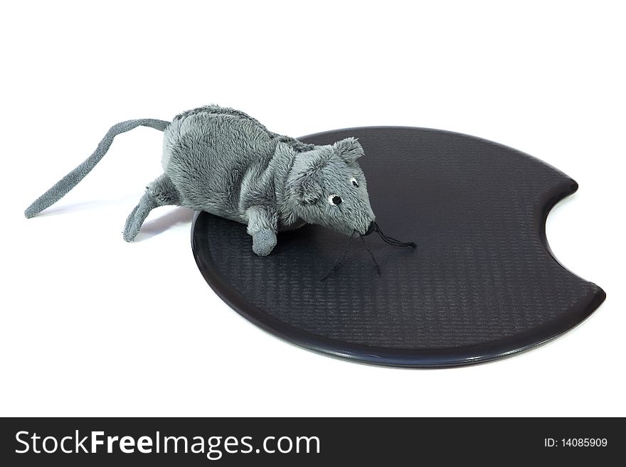 The mouse toy on a black computer rug. White background