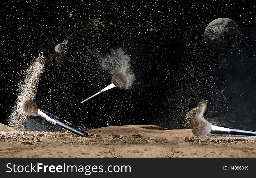 View of cosmetic brushes jumping over powder surface. View of cosmetic brushes jumping over powder surface