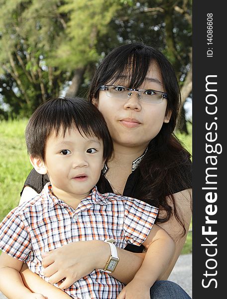 An Asian mother and her son at a public park. An Asian mother and her son at a public park