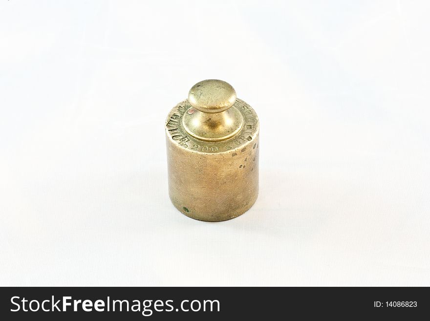 An antique iron weight on white background, useful for conceptual