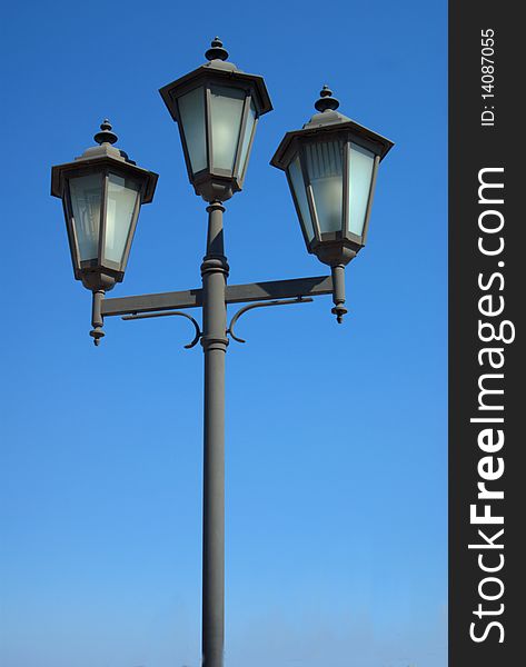 Old-fashioned street lantern on blue background